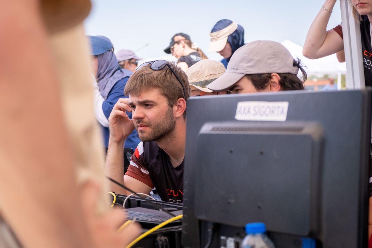 A team member driving the rover from the mission control station