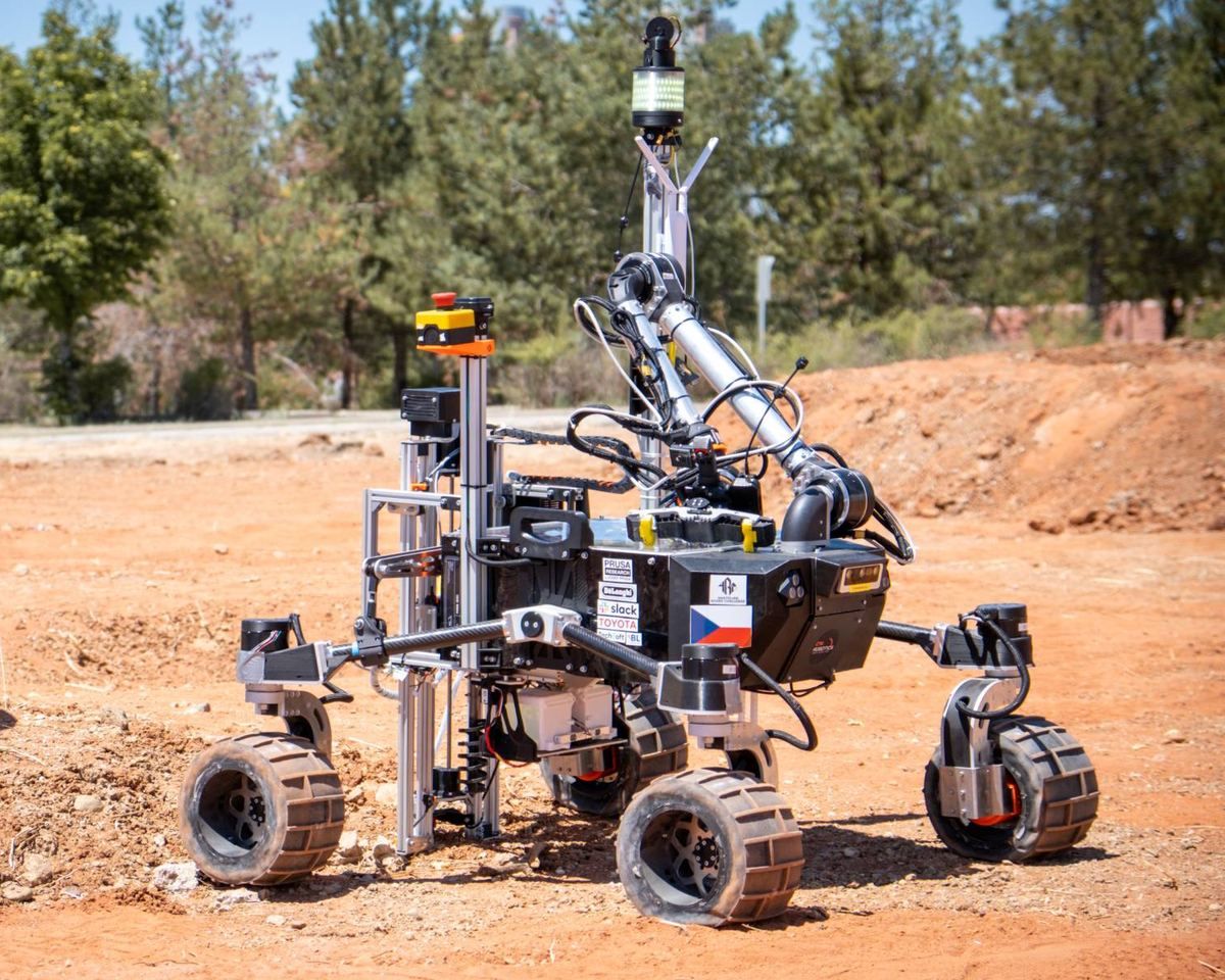 Perun Gen 3 on red terrain, with its robotic arm and drilling module