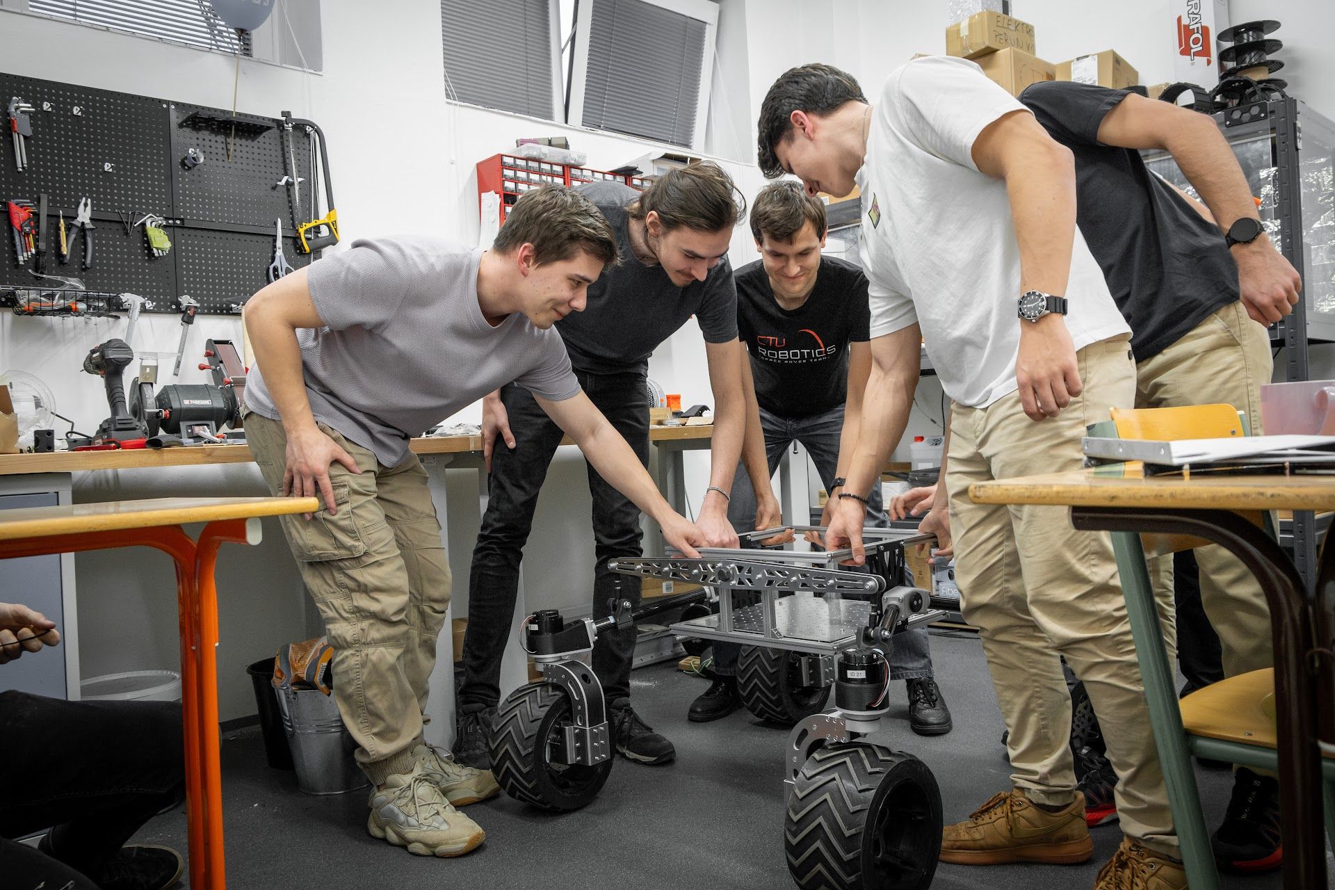 Team members gathered around Perun Gen 3 during its assembly in the workshop